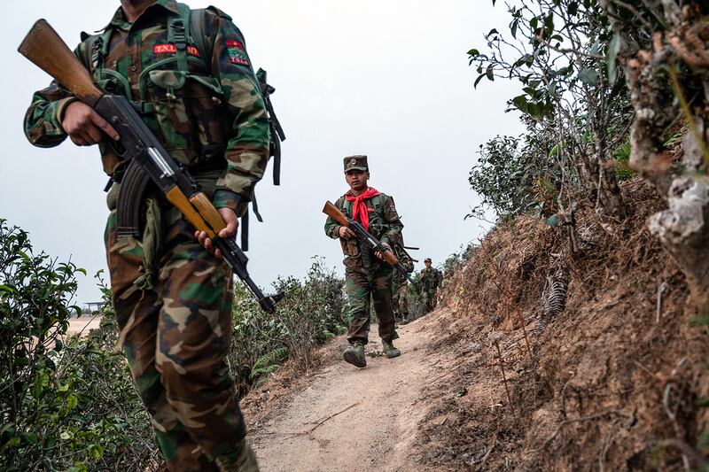 Ethnic rebel group Ta'ang National Liberation Army patrol near Namhsan Township in Myanmar's northern Shan State. (AFP)